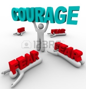9748121-one-person-stands-holding-the-word-courage-having-conquered-his-fear-while-others-around-him-succumb